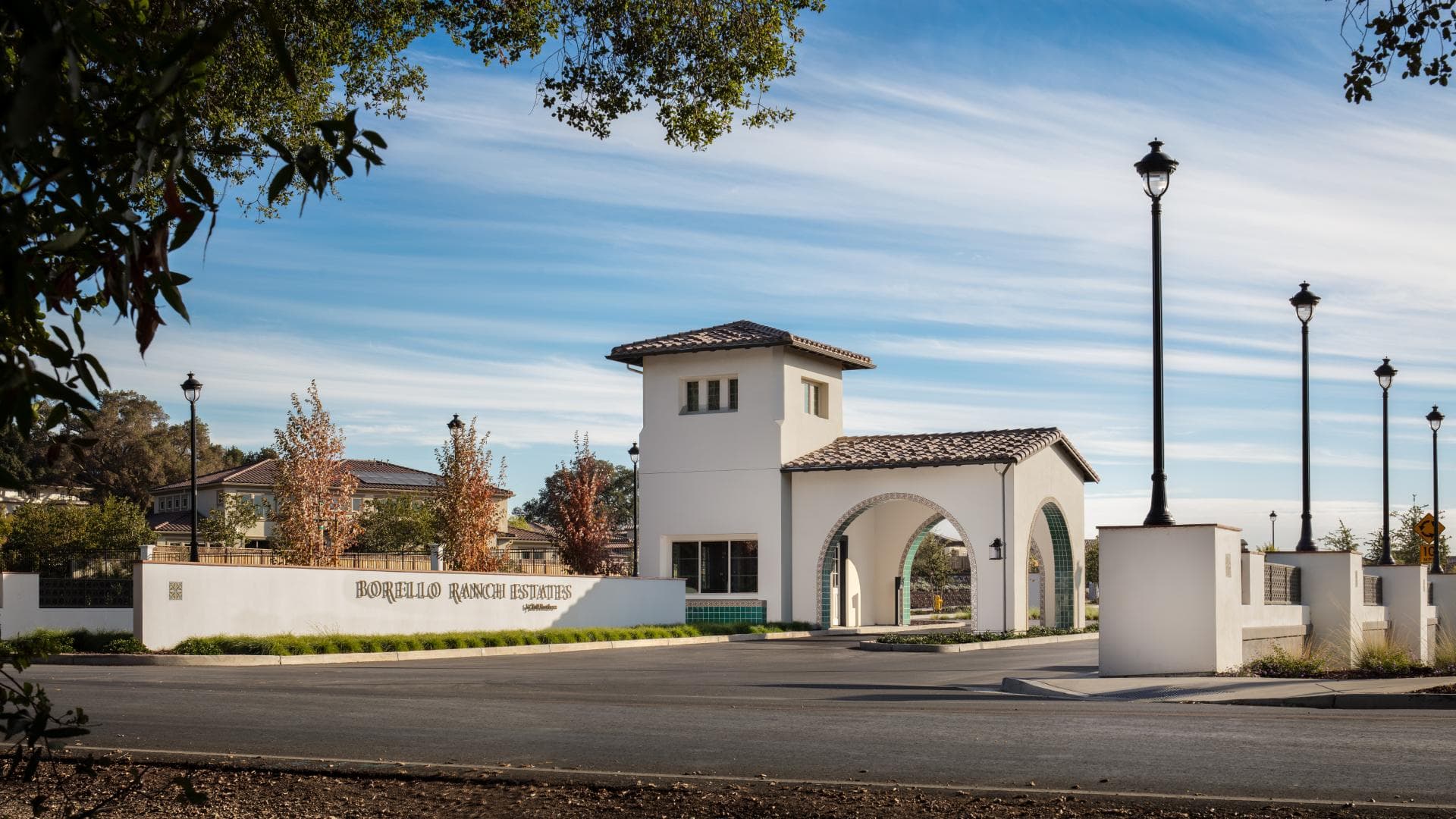 The Borello Ranch Estates entry monument and gatehouse at dusk